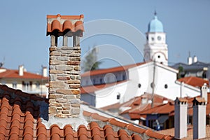 Red tiled roofs with stone chimneys