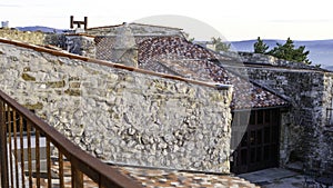 Red tiled roofs with stone walls and chimneys