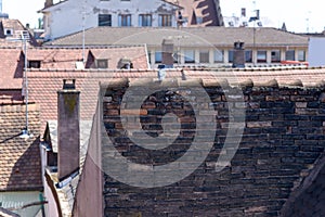 Red tiled rooftops in a town with antennae