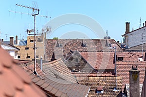 Red tiled rooftops in a town with antennae