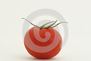 Red tomato against white background