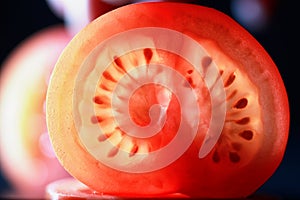 Red tomato cut in half with the texture of seeds