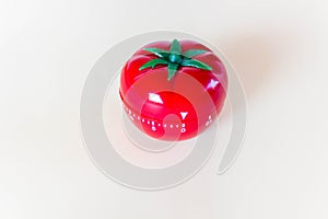 Red tomato-shaped timer on white background. Home related, home staying. Free copy space