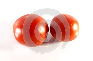 Red tomato on white background. Summer closeup view. Vegan food isolated