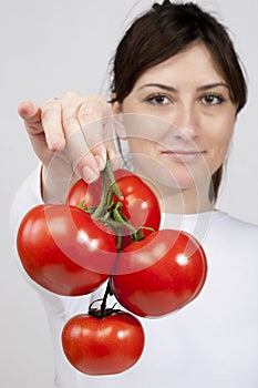 Red tomato in woman hands
