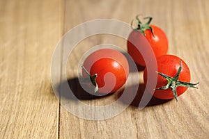 Red tomato on wooden background