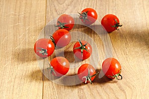 Red tomato on wooden background