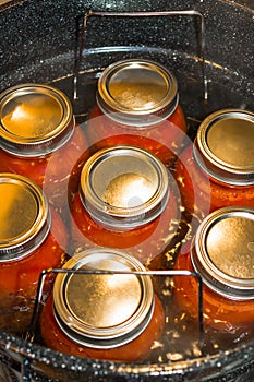 Homegrown tomatoes and stove top water bath canning photo