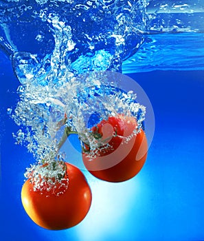 Red tomatoes in water