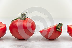 Red tomatoes on the white wood table