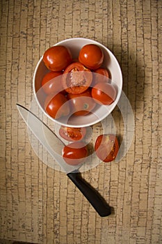 Red tomatoes on wooden background