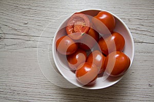 Red tomatoes on wooden background