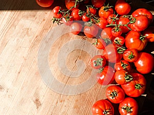 Red tomatoes on wooden background. Fresh vegetables top view with copy space for text. Flat lay. The concept of the harvest, veget