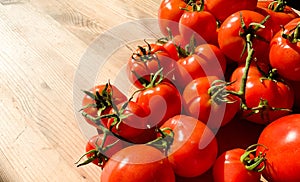 Red tomatoes on wooden background. Fresh vegetables top view with copy space for text. Flat lay. The concept of the harvest, veget