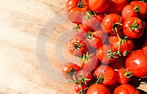 Red tomatoes on wooden background. Fresh vegetables top view with copy space for text. Flat lay. The concept of the harvest, veget