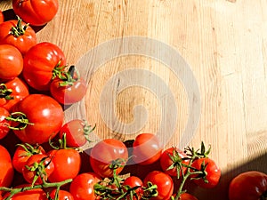 Red tomatoes on wooden background. Fresh vegetables top view with copy space for text. Flat lay. The concept of the harvest, veget