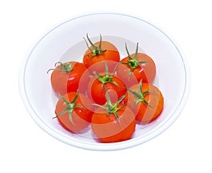 Red tomatos in round plate