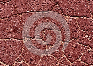 Red toned damaged asphalt road texture.