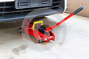 Red tool jack lift car for repair check Maintenance