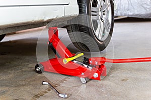 Red tool jack lift car for repair check Maintenance