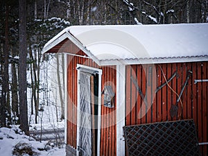 a red tool shed during the winter