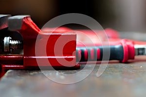 Red tools on a work table on a black background, toolroom concept