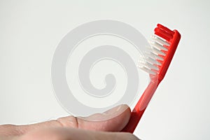Red toothbrush in hand