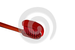 Red toothbrush with red toothpaste isolate on a white background close-up.