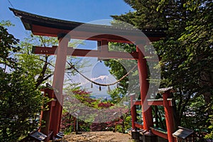 Red tori with Mount Fuji in the background at Chureito pagoda