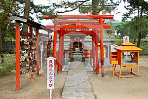 red tori tori stands outside in the middle of a garden