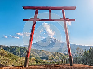 Red torii of Chureito temple with Mountain Fuji as background