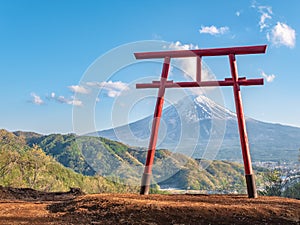 Red torii of Chureito temple with Mountain Fuji as background