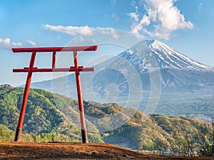 Red torii of Chureito temple with Mountain Fuji as background