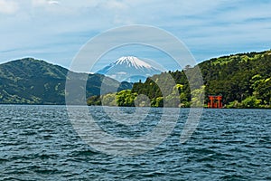 Red torii gate on the shore of Lake Ashi, near Mount Fuji in Hak