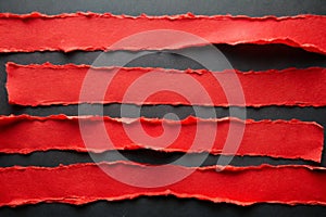 Red Torn Paper Strips on Black Background