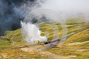 The red tourist vintage steam train ascending to the Brienzer Rothorn