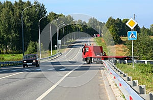 Red tow truck. Road signs