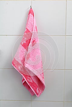 Red towel for wipe hand in toliet room on wall