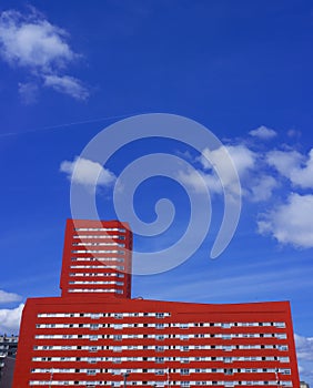 Red tower in the city with blue sky in the background