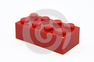 Red toy brick/plastic block on a white background