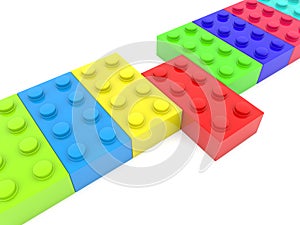 Red toy brick among a row of different colored toy bricks