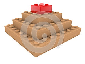 Red toy brick in a wooden pyramid