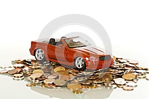 Red toy car on coins