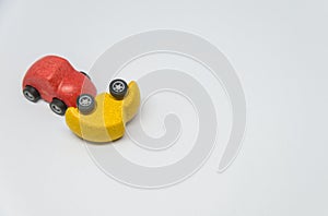 Red toy car crashed yellow toy car accident with white background