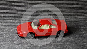 red toy car on a gray background