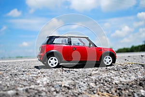 Red toy car on the road