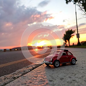 Red toy car, sunset
