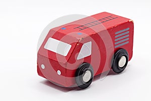 A red toy car in wood on white background