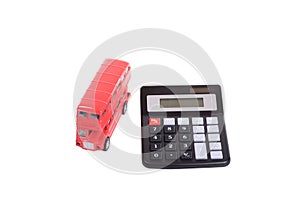 Red toy double-decker British bus and calculator