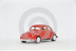 red toy retro car sideways on a white background